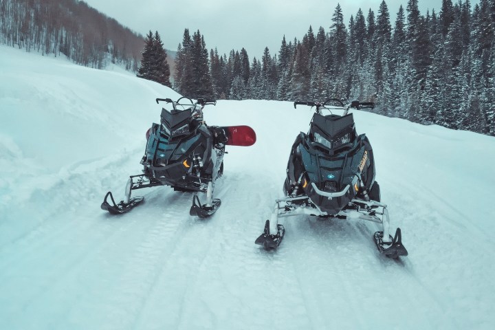 a group of people riding skis on top of a snow covered slope
