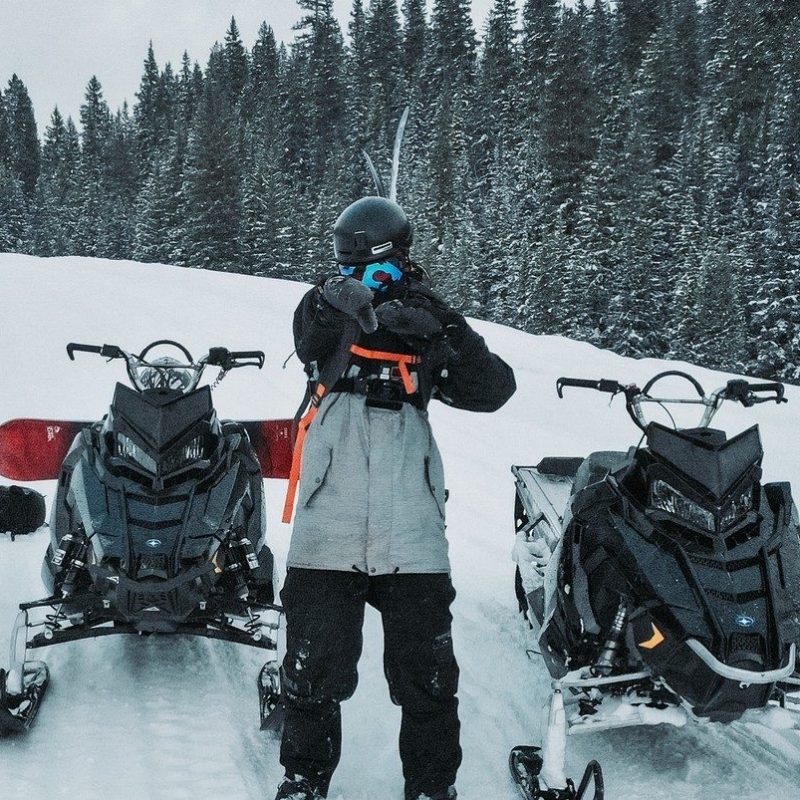 a group of people standing on top of a snow covered slope