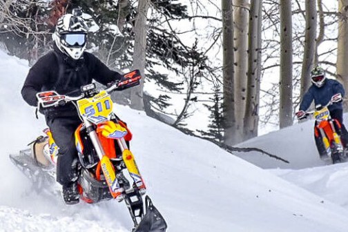 a man riding skis down a snow covered slope