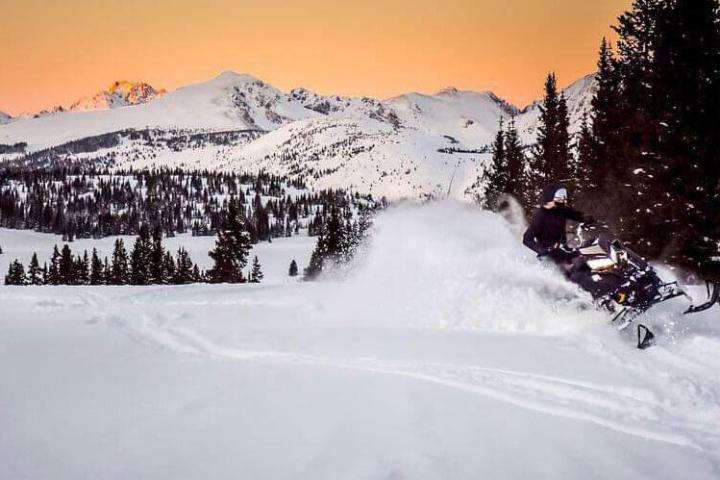 a man riding skis down a snow covered slope