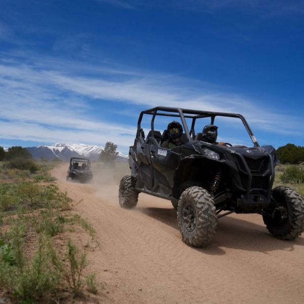 a truck driving down a dirt road