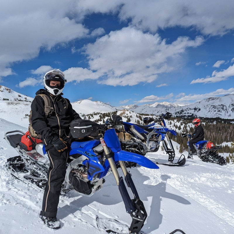 a group of people riding skis on top of a snow covered slope