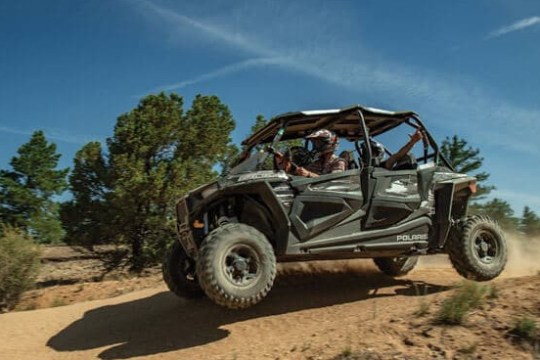 a truck driving down a dirt road