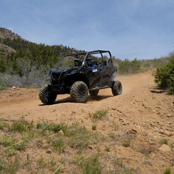 a truck driving down a dirt road
