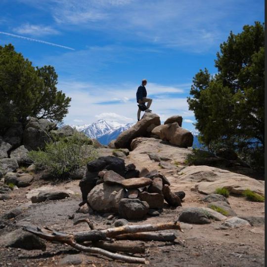 a man standing on a rocky hill