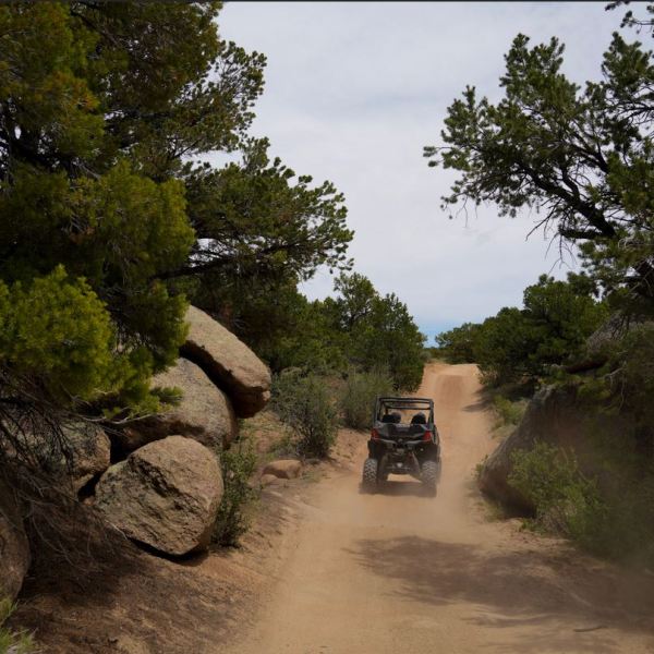 a car driving down a dirt road