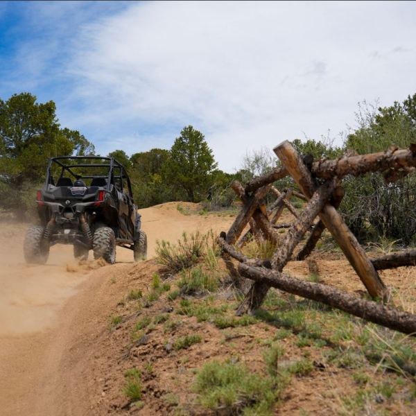 a truck driving down a dirt road