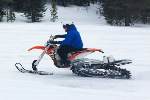 a man riding skis down a snow covered slope